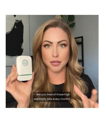 Person holding a StopWatt plug-in device at home